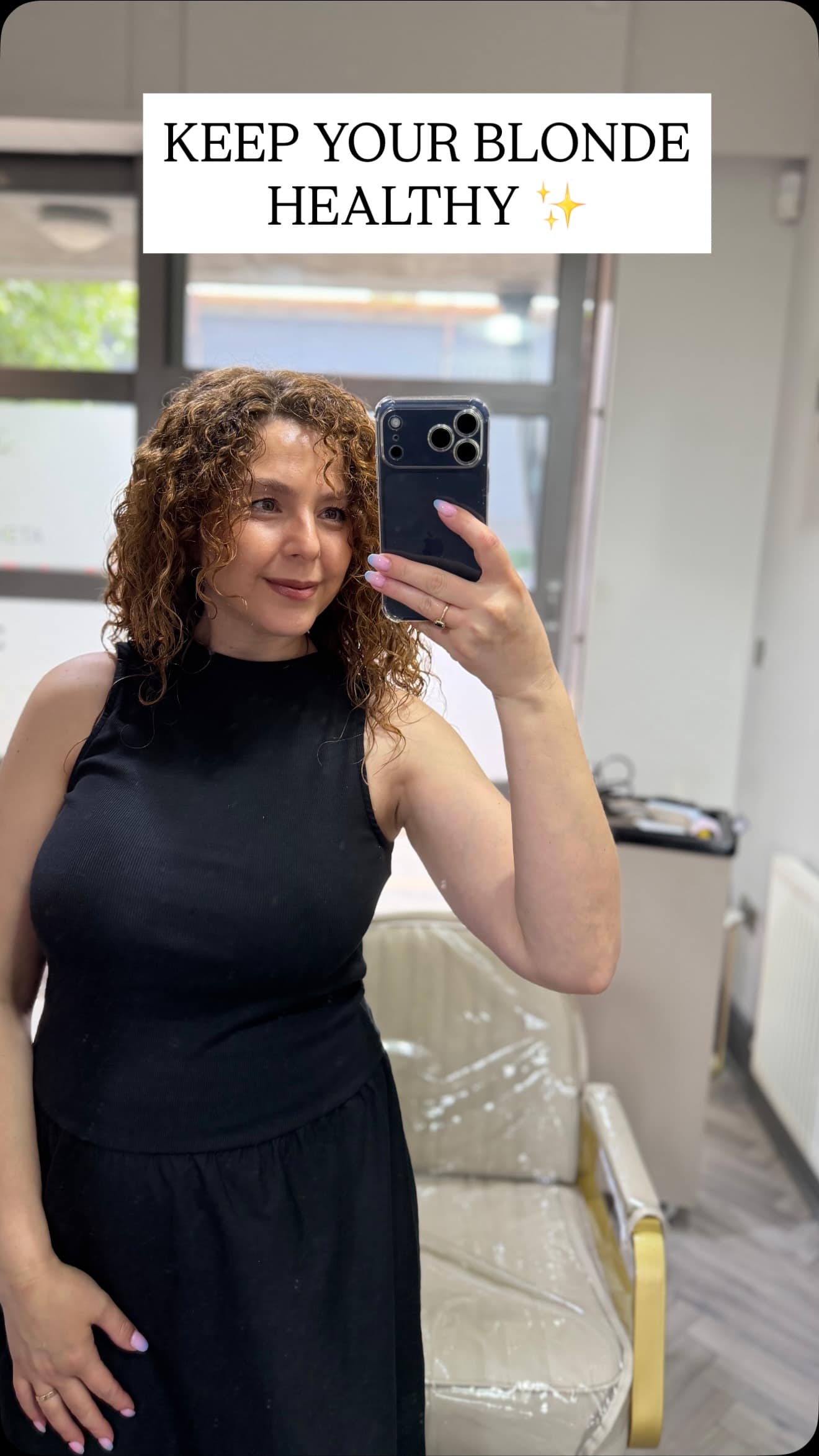Greta taking a mirror selfie in her Manchester salon chair